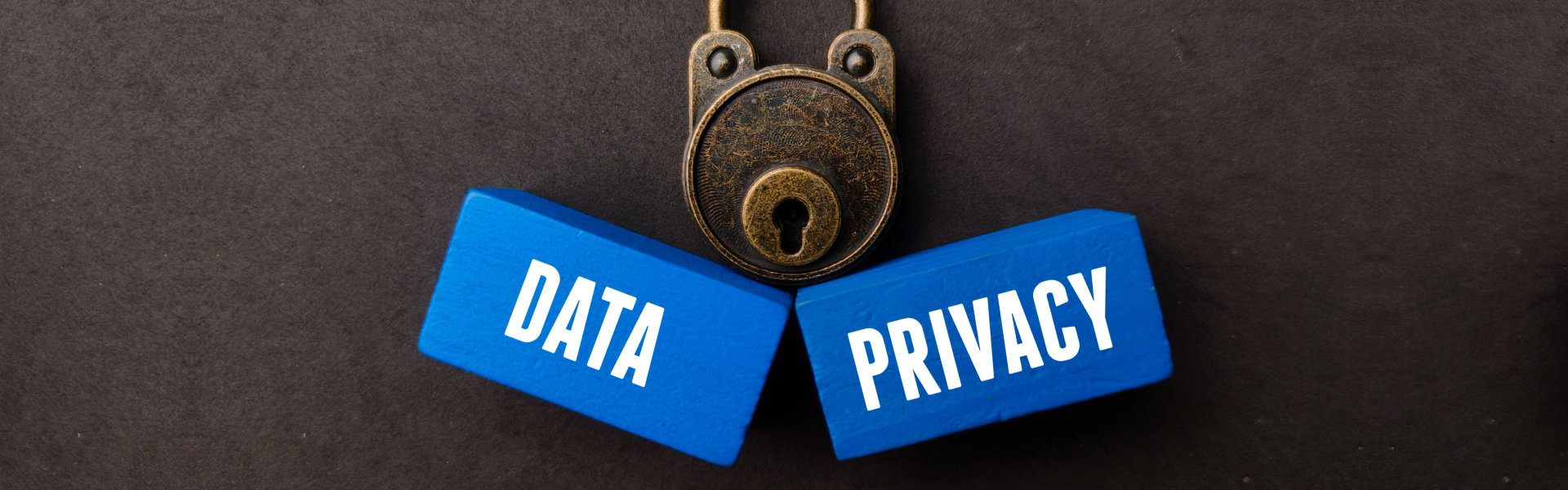 A vintage padlock and blue wooden cubes with the words DATA and PRIVACY